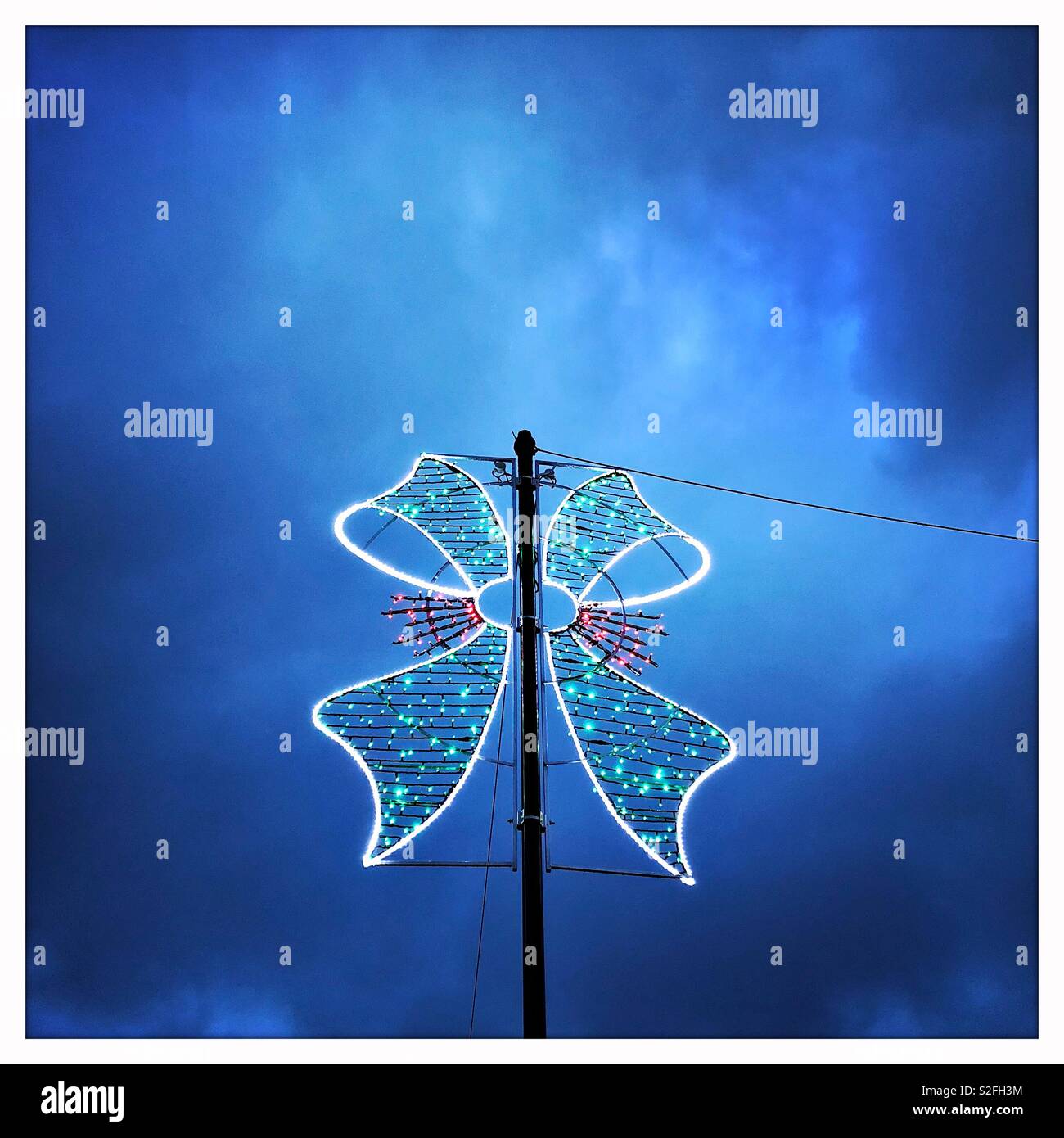 Christmas street lights in Dumfries town centre, Scotland, taken at the blue hour before it gets completely dark. Stock Photo