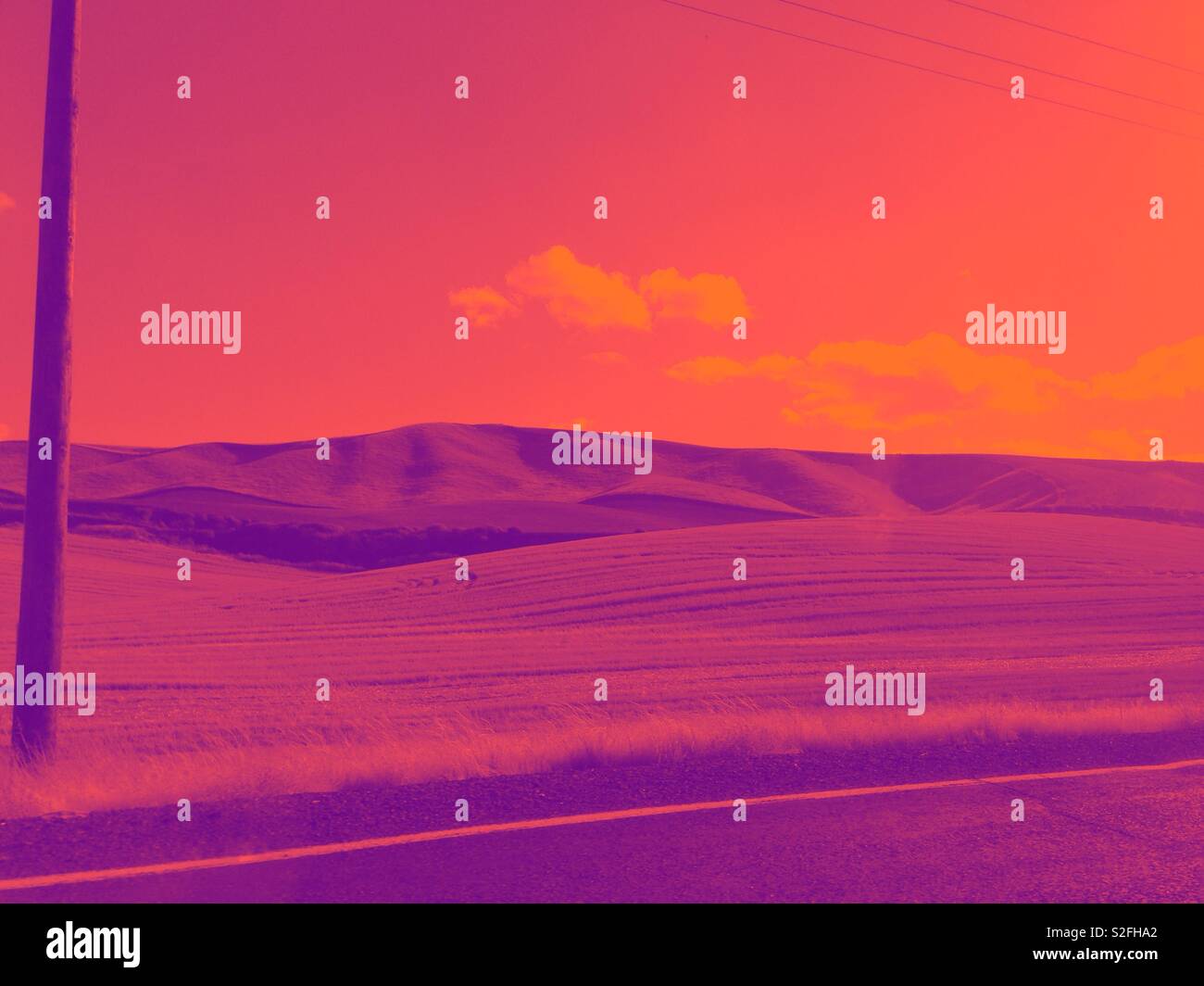 Duotone photo of Eastern Washington hillside resembles alien landscape in magenta and orange Stock Photo