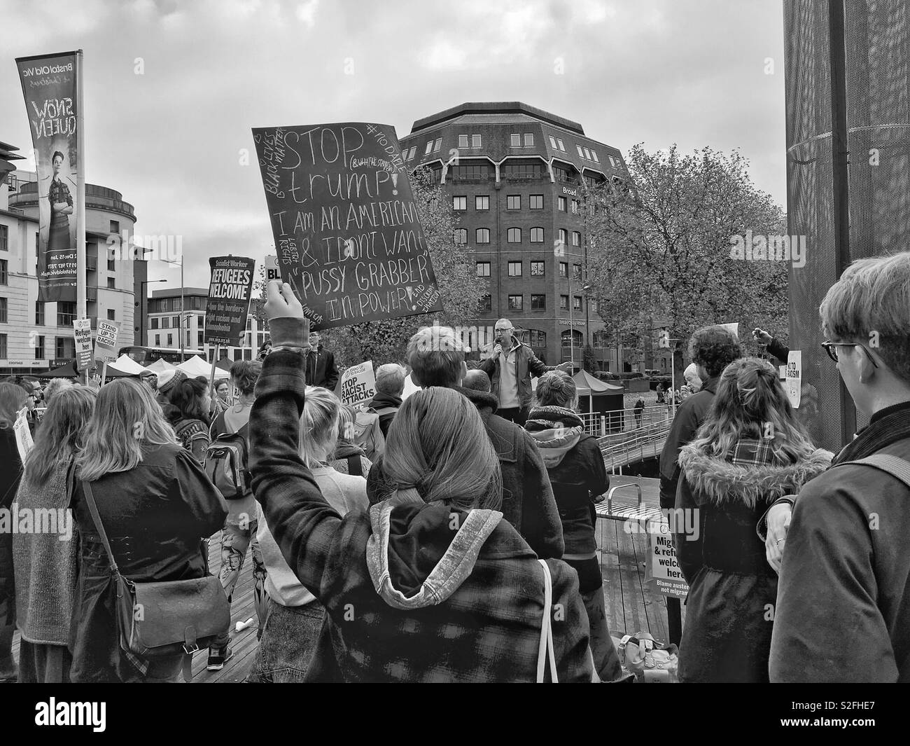 A woman holds a placard aloft at a demonstration against the election of Donald Trump as US president in Bristol, UK on 12 November 2016 - Smartphone Captured Stock Image