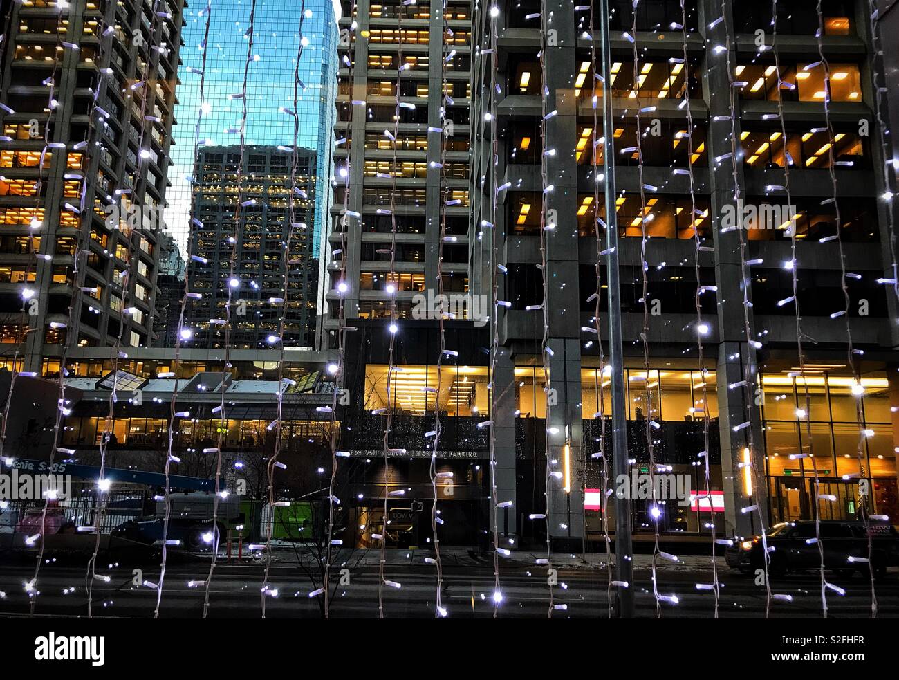 The streets of downtown Calgary through a window covered in Christmas