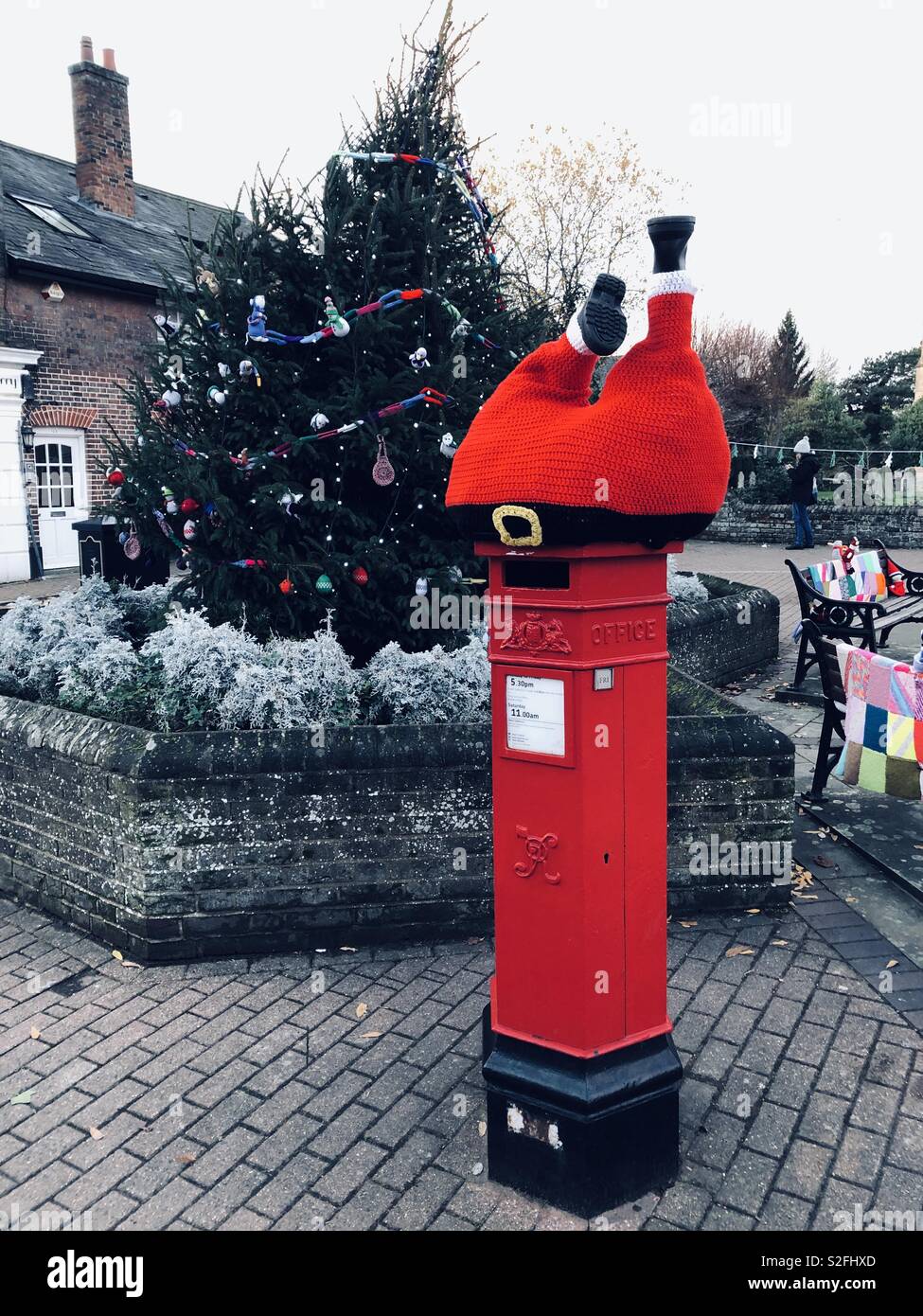 Santa mistaking a Georgian pillar box for a chimney in Tring town centre Stock Photo
