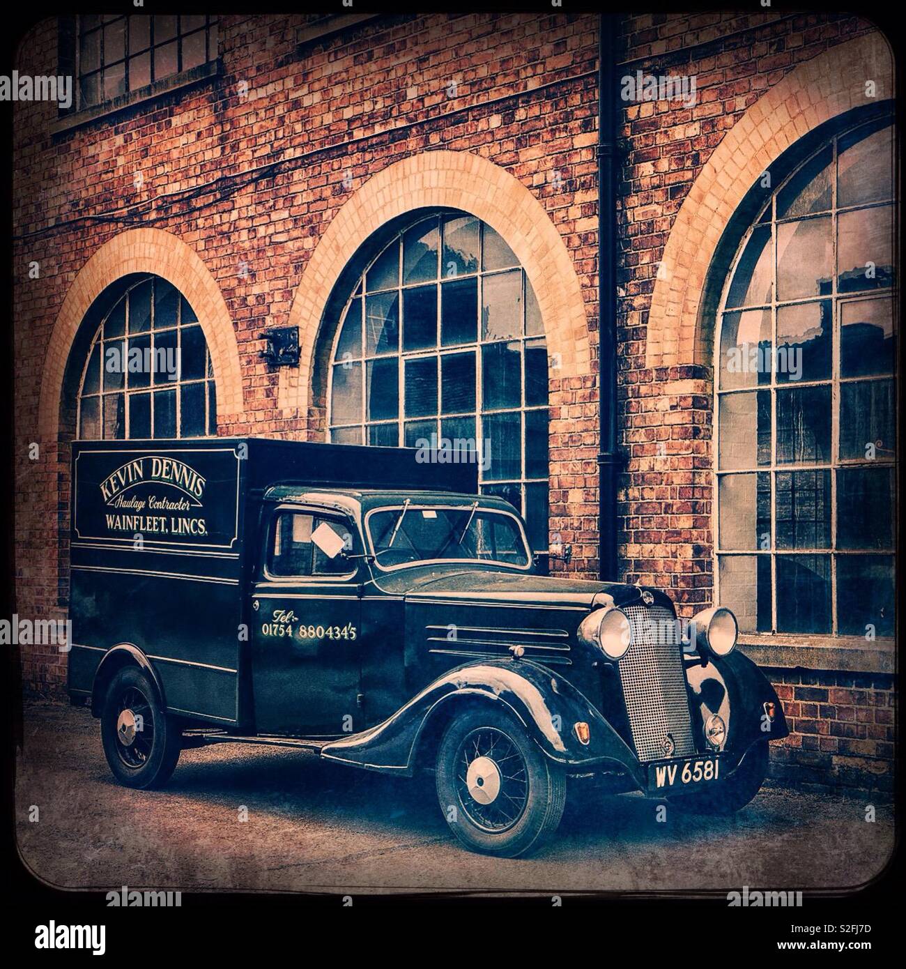Vintage van in front of some old factory buildings. - Smartphone Captured Stock Image