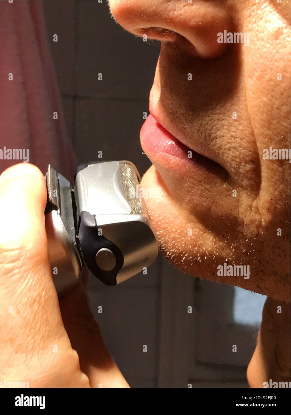 Man shaving his chin. Close view. - Smartphone Captured Stock Image