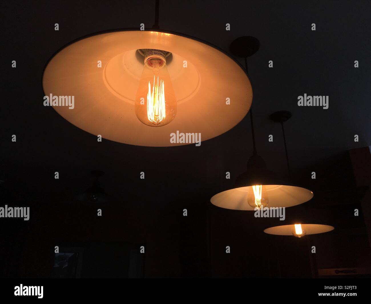 Three tungsten l-carbide incandescent filament lights with exposed ...