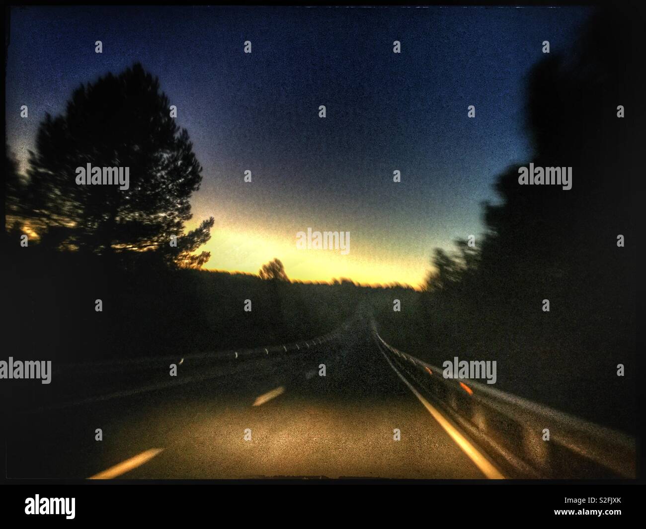 Driving into a setting Sun, Catalonia, Spain. - Smartphone Captured Stock Image