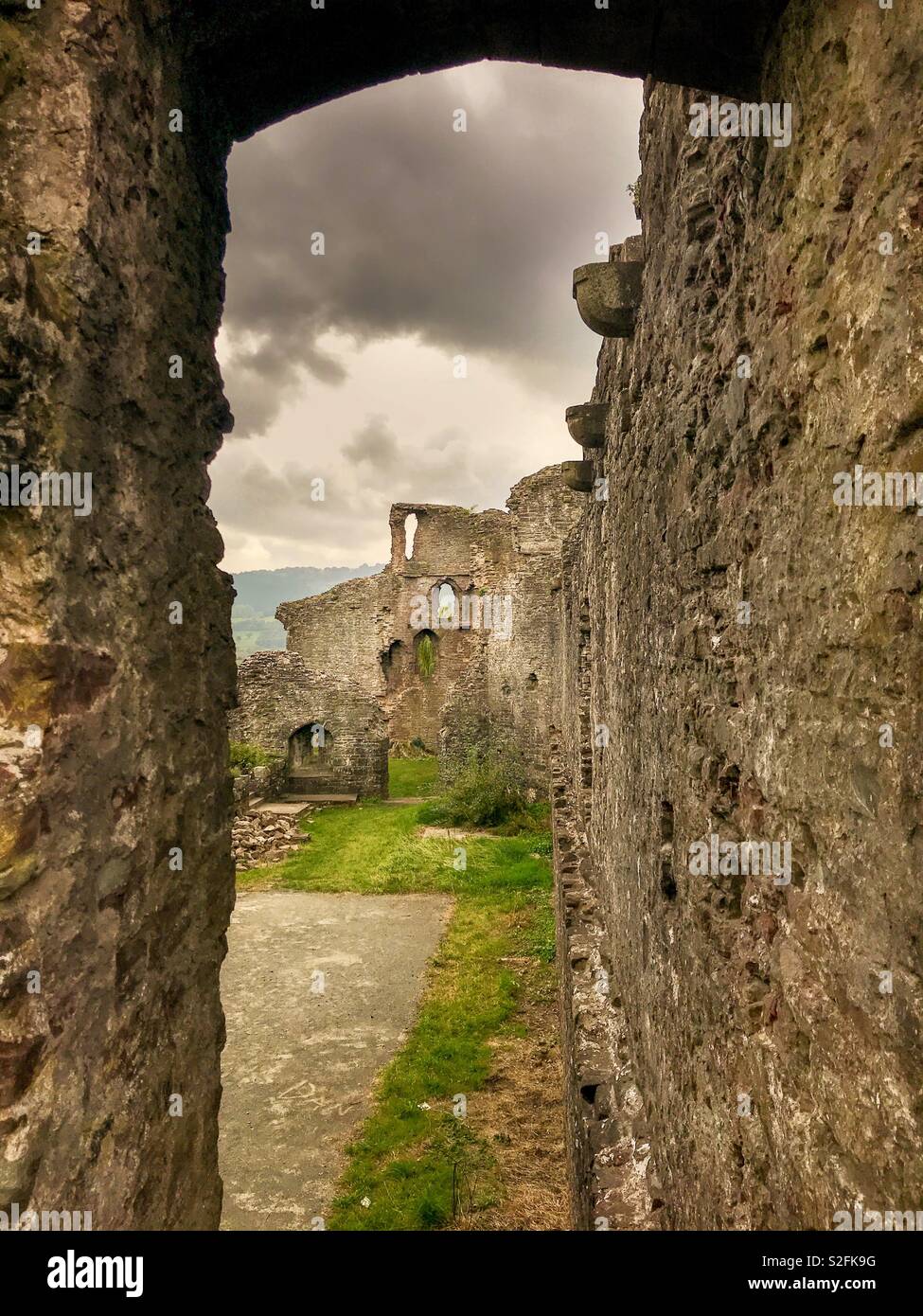 Ruined walls of Abergavenny castle framed by an archway - Smartphone Captured Stock Image