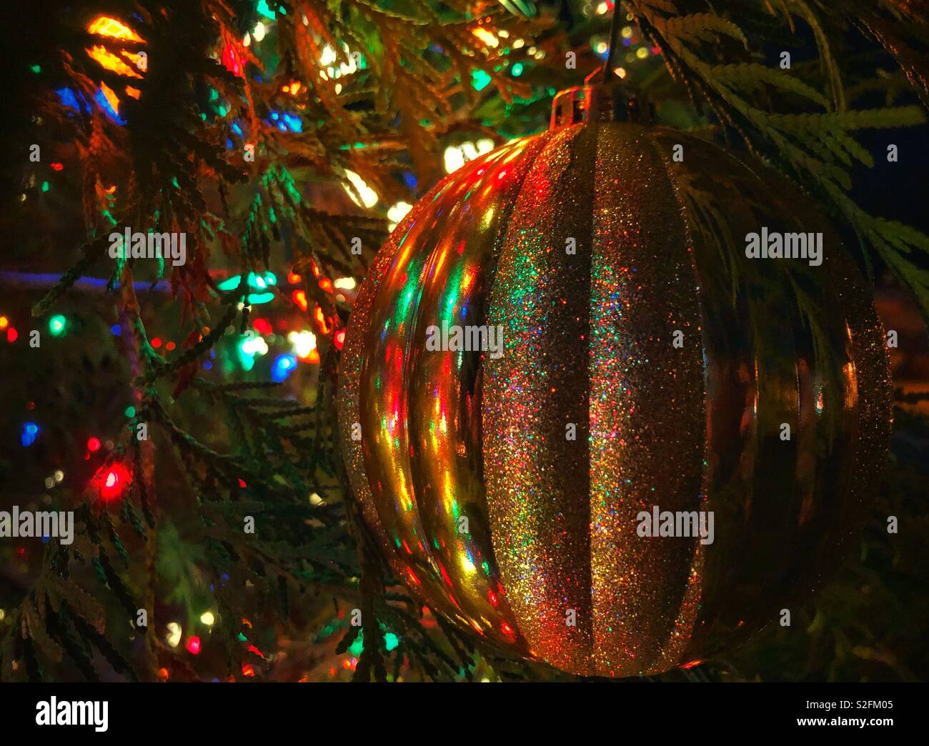 Christmas lights are reflected in a gold Christmas ball, Dec. 23, 2018, in Bayou La Batre, Alabama. Stock Photo