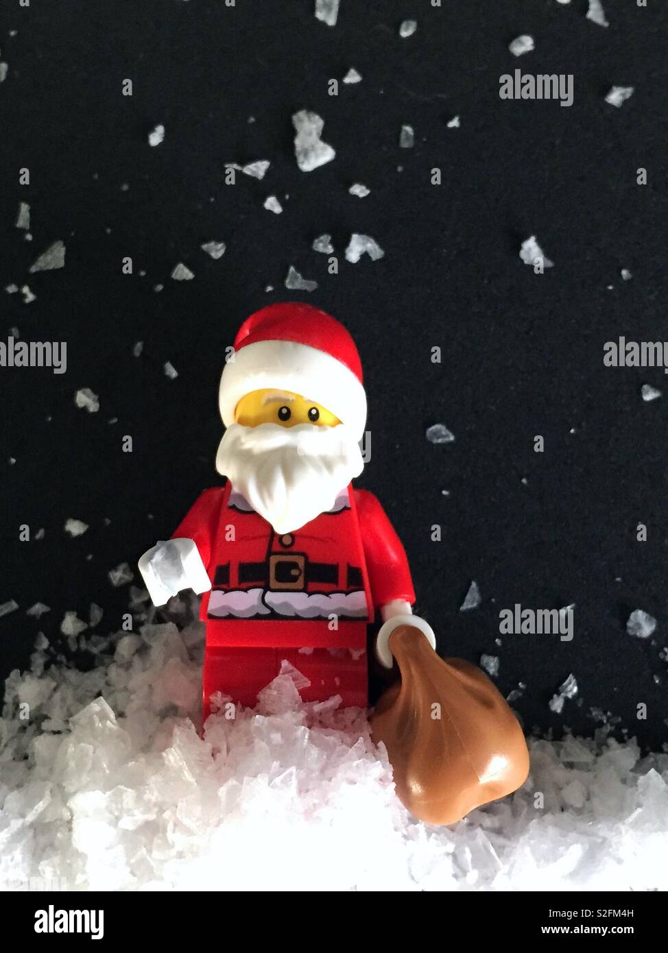 Santa with snow falling around made from salt flakes.  Christmas quirky - Smartphone Captured Stock Image