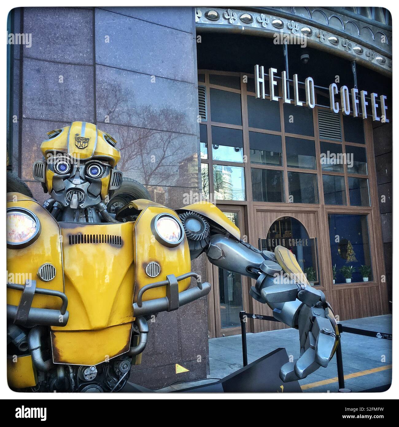 Bumblebee transformer greetings customers of Hello Coffee cafe in Beijing, China - Smartphone Captured Stock Image