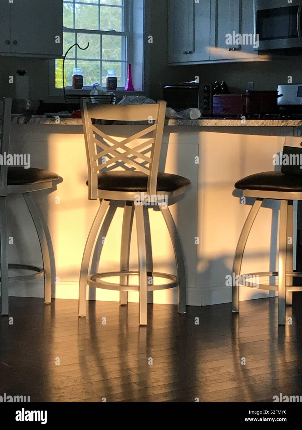 Sunlight and kitchen chairs. Stock Photo