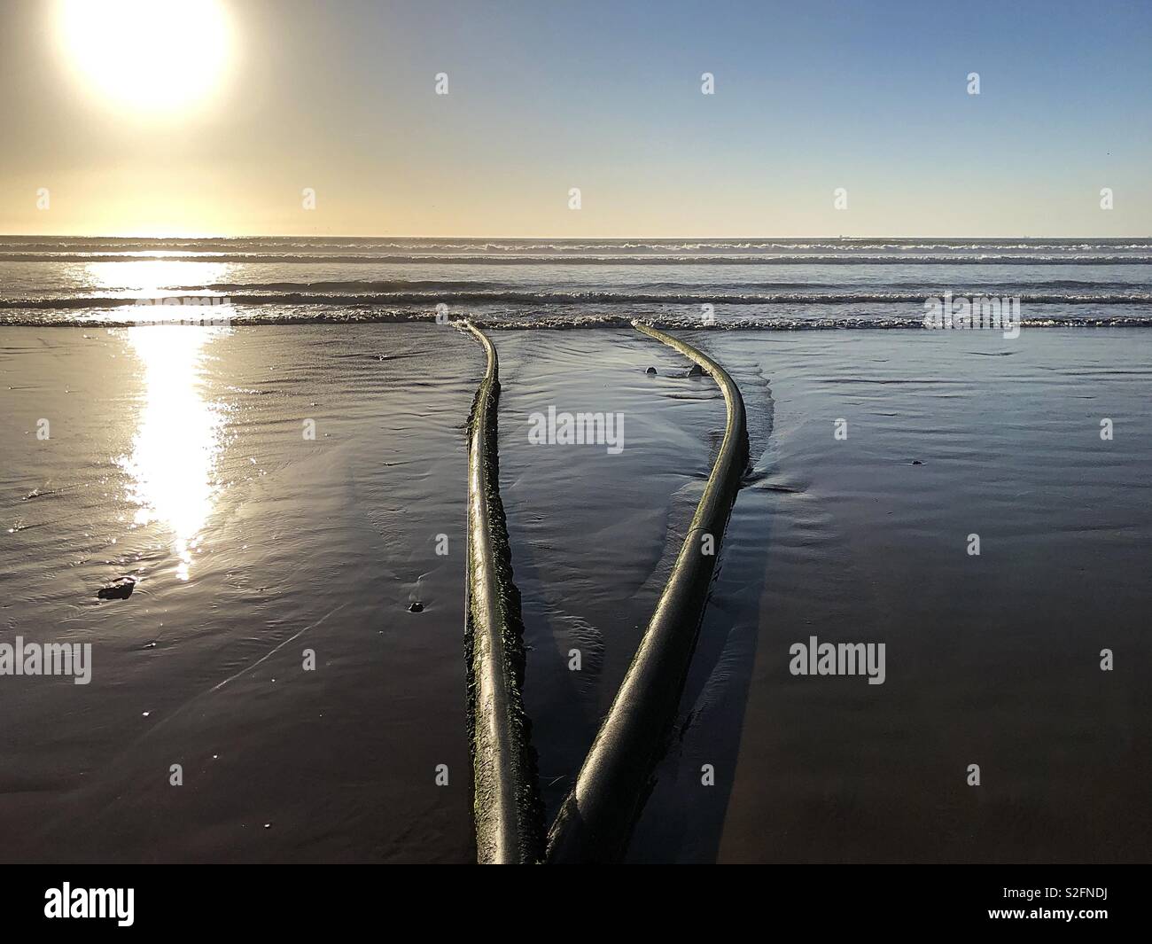 Waste pipes out to the Atlantic Ocean sea from Agadir beach, Morocco - Smartphone Captured Stock Image