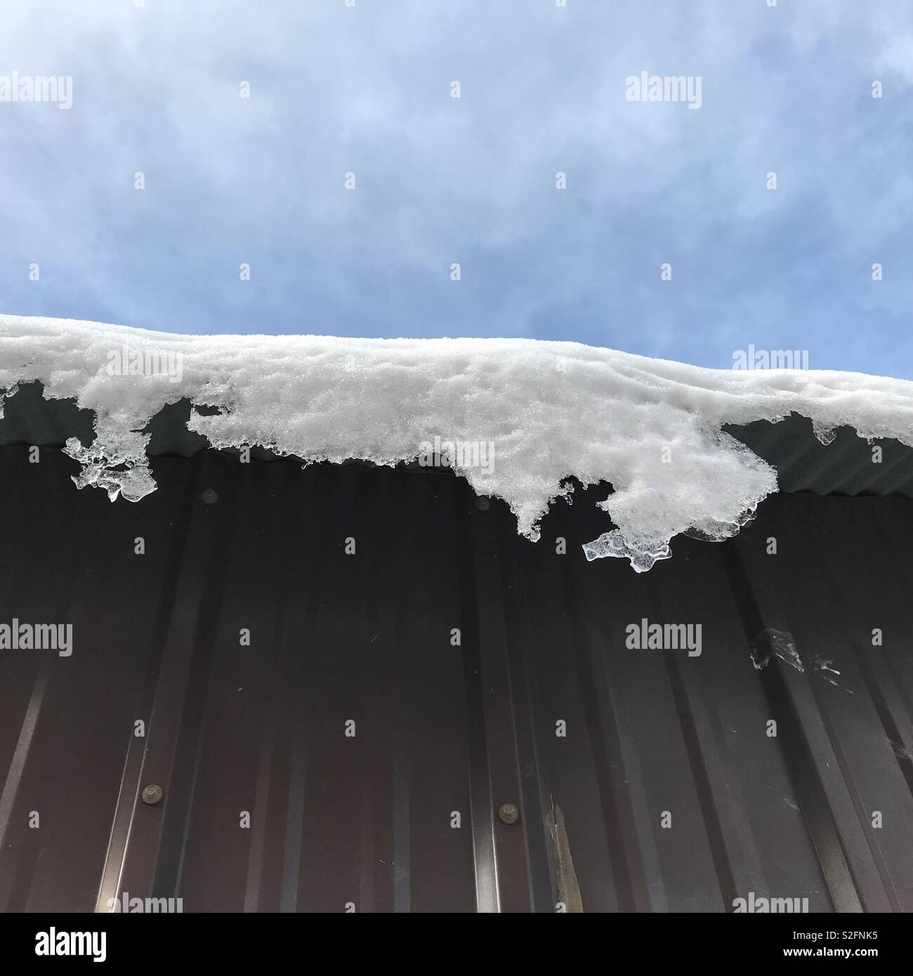 Snow falling off the roof Stock Photo Alamy
