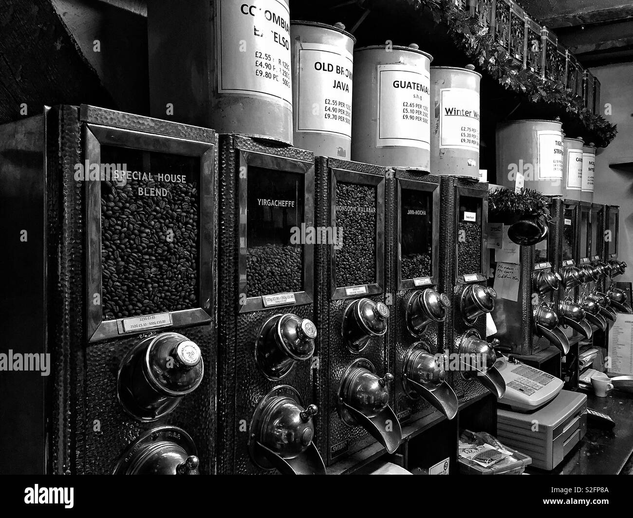 Vintage coffee dispensers displaying an array of coffee beans in a shop, blending tradition with specialty coffee options for coffee lovers - Smartphone Captured Stock Image