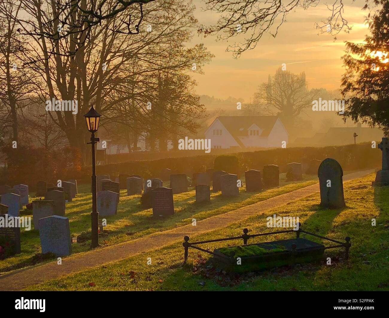 Path through churchyard at sunset. - Smartphone Captured Stock Image Path through churchyard at sunset. - Smartphone Captured Stock Image