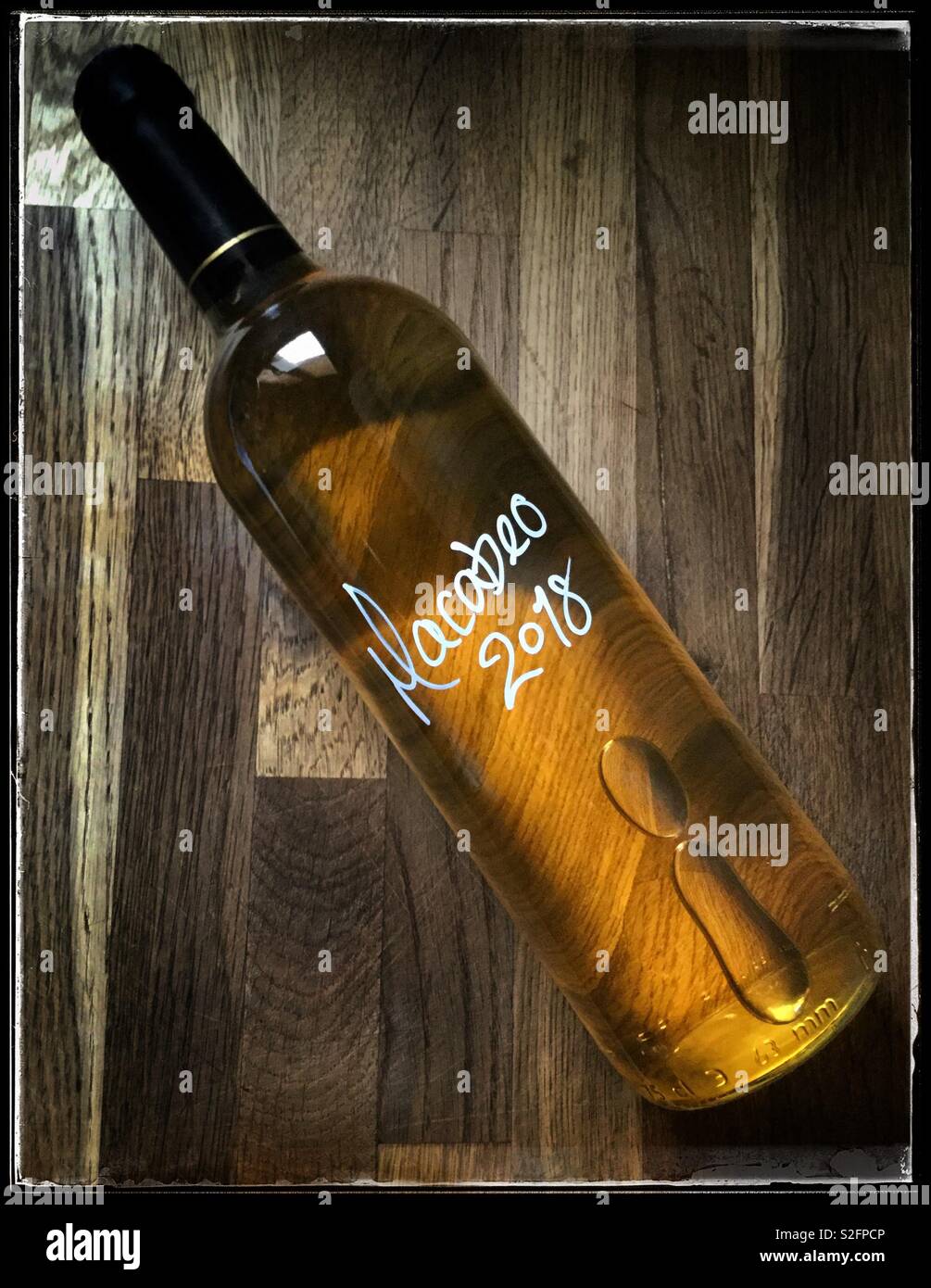A bottle of homemade Macabeo white wine. - Smartphone Captured Stock Image