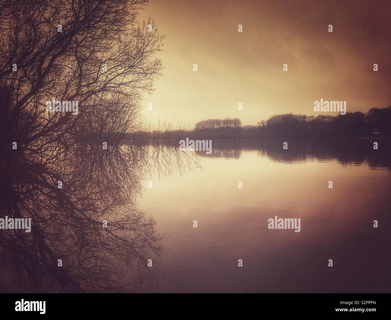 Mist over Rivington reservoir early in morning Stock Photo