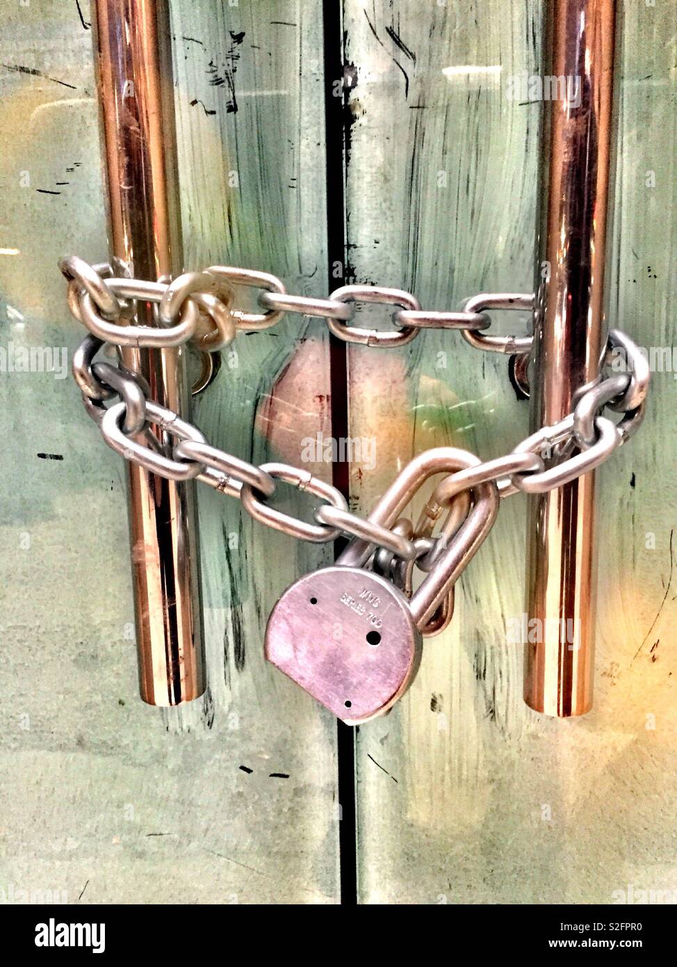 Padlock and chain on the door handles Stock Photo - Alamy