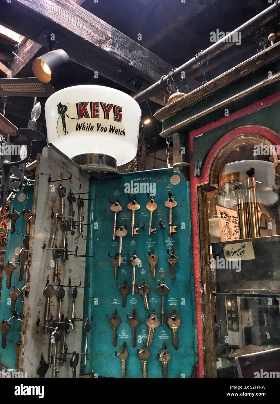 Vintage key cutting display in an old salvage yard, keys while you wait