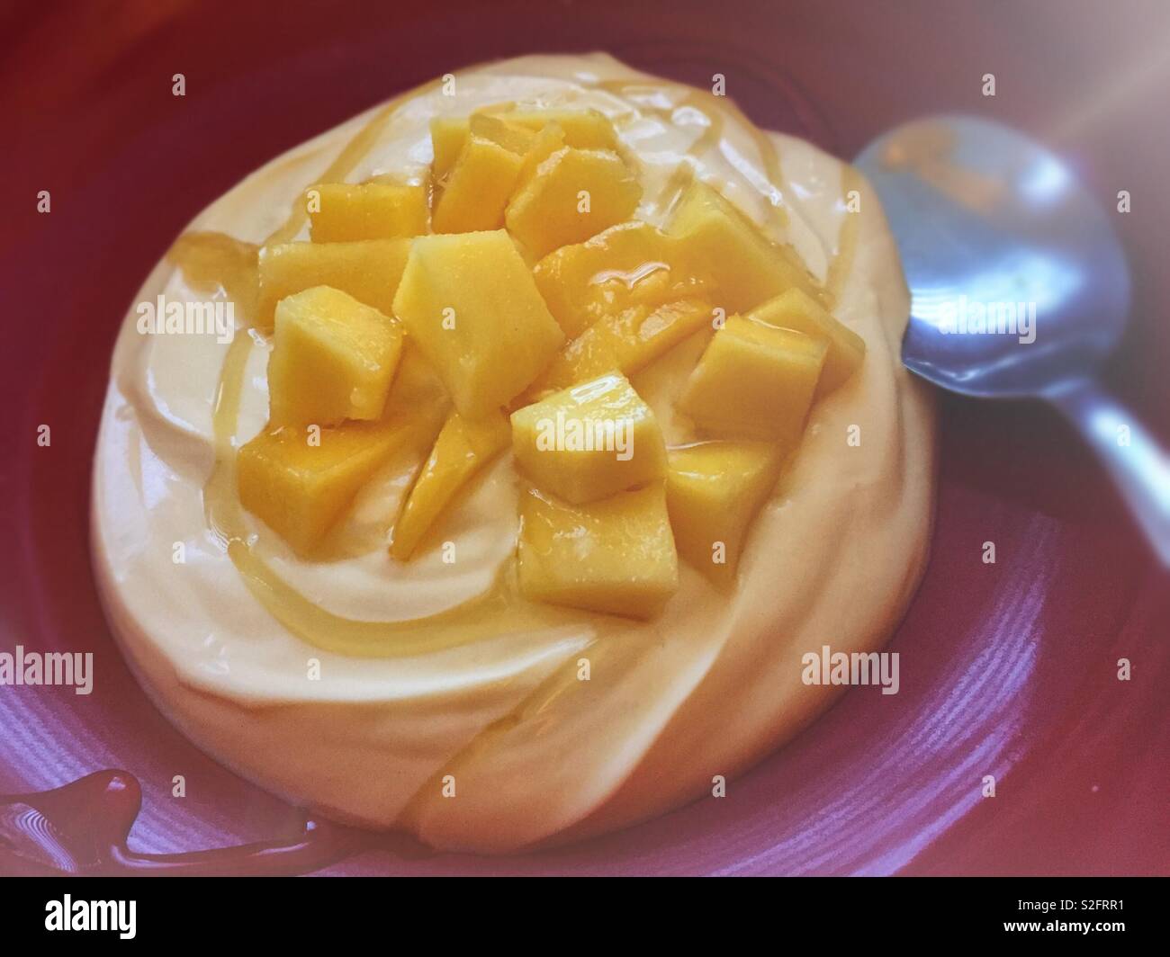 Healthy eating and diet for the New Year.  2019 Resolution for losing weight.  Mango fruit with yoghurt and cinnamon syrup. - Smartphone Captured Stock Image