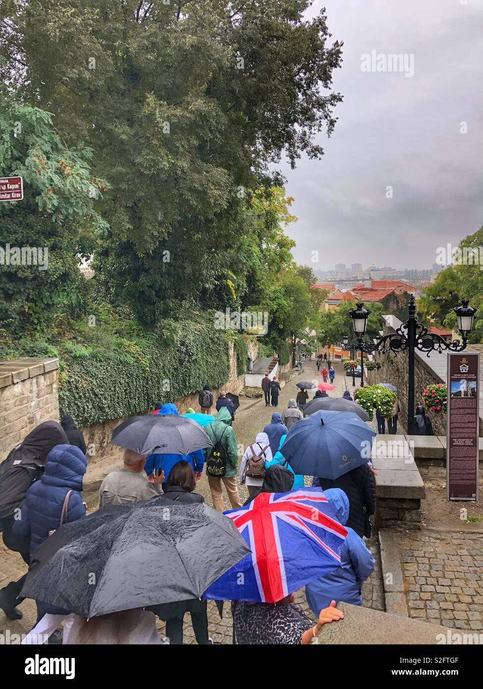 A tourist group walking down a cobblestone street in Plovdiv, Bulgaria. - Smartphone Captured Stock Image