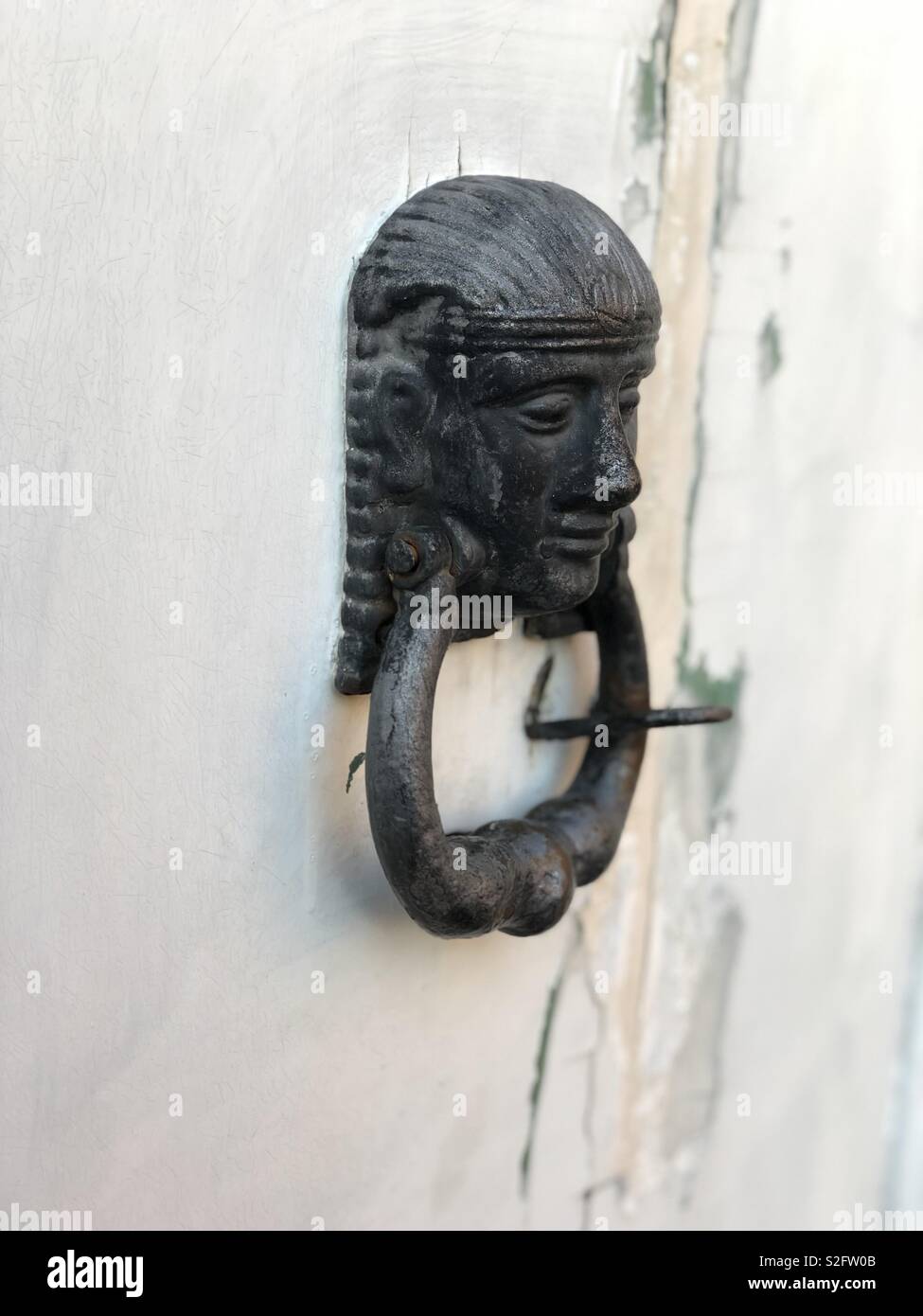 Old knock door, egyptian style on a white wooden door Stock Photo