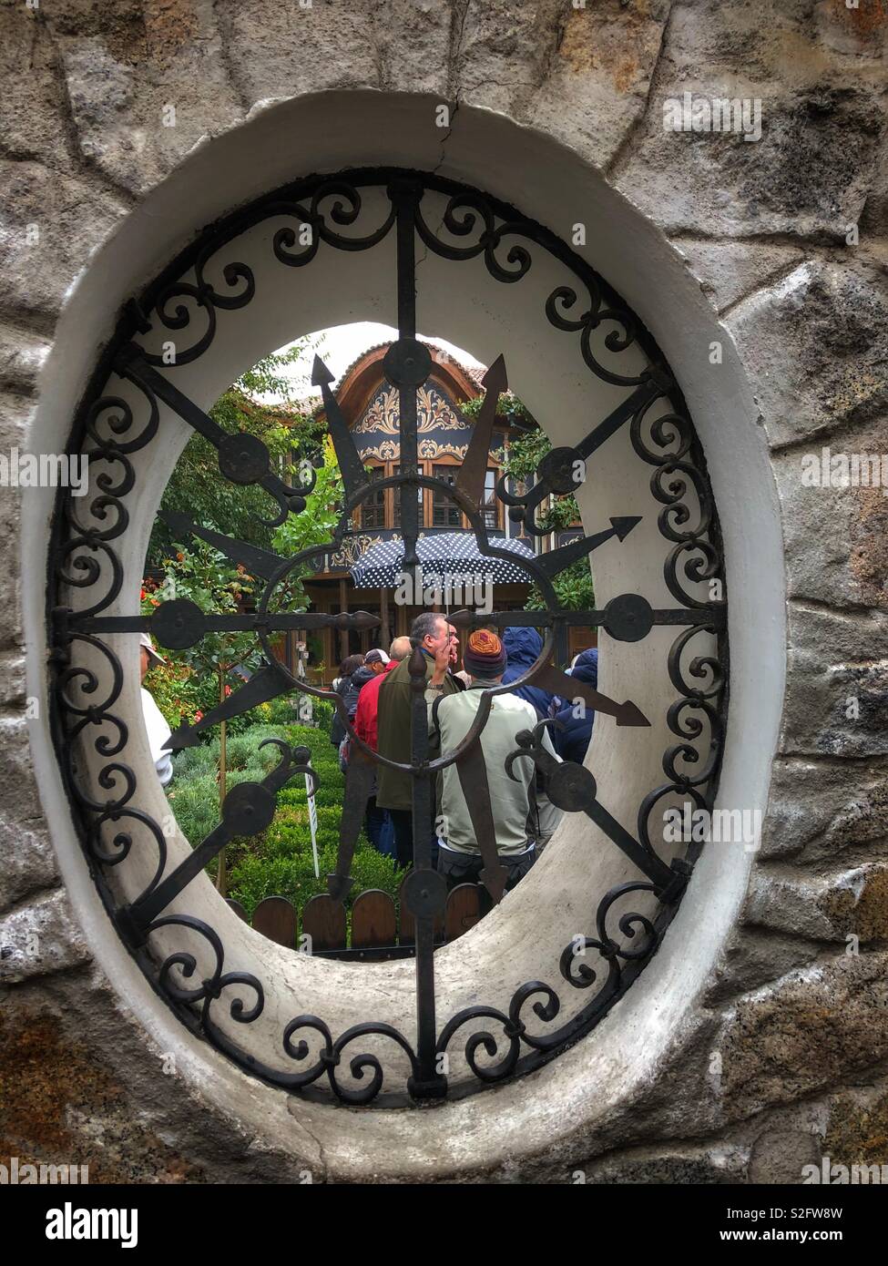 Looking through a window carved into a stone wall. Stock Photo