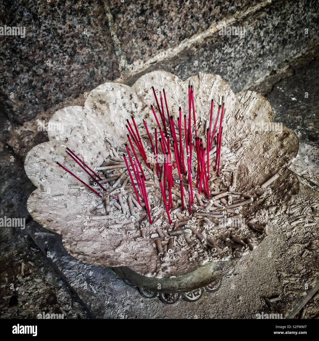 Burnt incense sticks outside the Hung Shing Temple in Wan Chai, Hong Kong Island - Smartphone Captured Stock Image