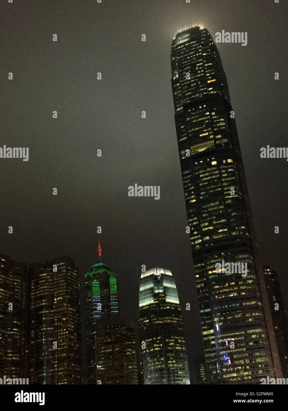 Hong Kong Island commercial skyscrapers at night: (l to r) Exchange Square, The Center, 1ifc, and 2ifc, Hong Kong's second tallest - Smartphone Captured Stock Image