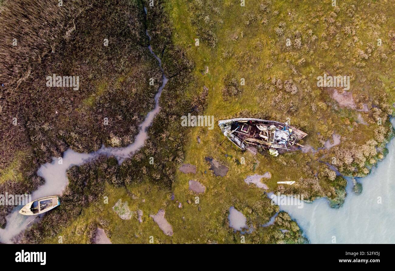 Aerial shot of some old boats sitting on estuary mud - Smartphone Captured Stock Image