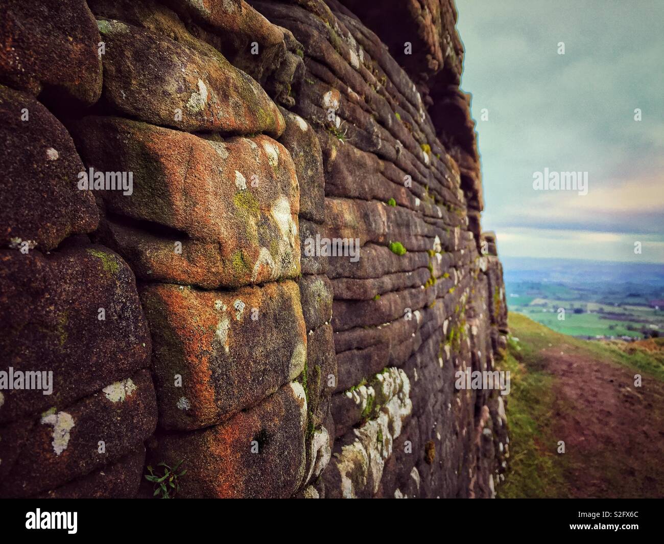 A rocky outcrop on The Skirrid mountain in the Brecon Beacons National Park, near Abergavenny, showing the layered strata in the sandstone sedimentary rock. - Smartphone Captured Stock Image