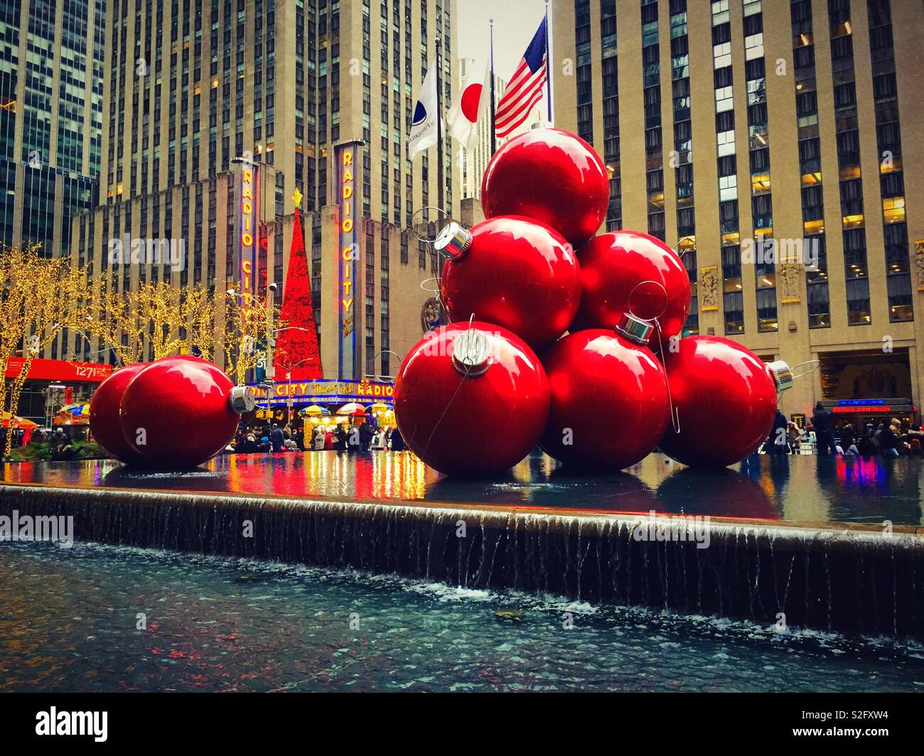 Huge Christmas ornament display on sixth Avenue in front of radio city music Hall, NYC, USA - Smartphone Captured Stock Image