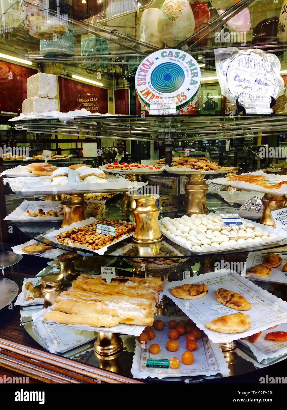 Pastries and assorted cakes and baked goods in shop window of Casa Mira pastry shop or bakery in Madrid Spain Stock Photo