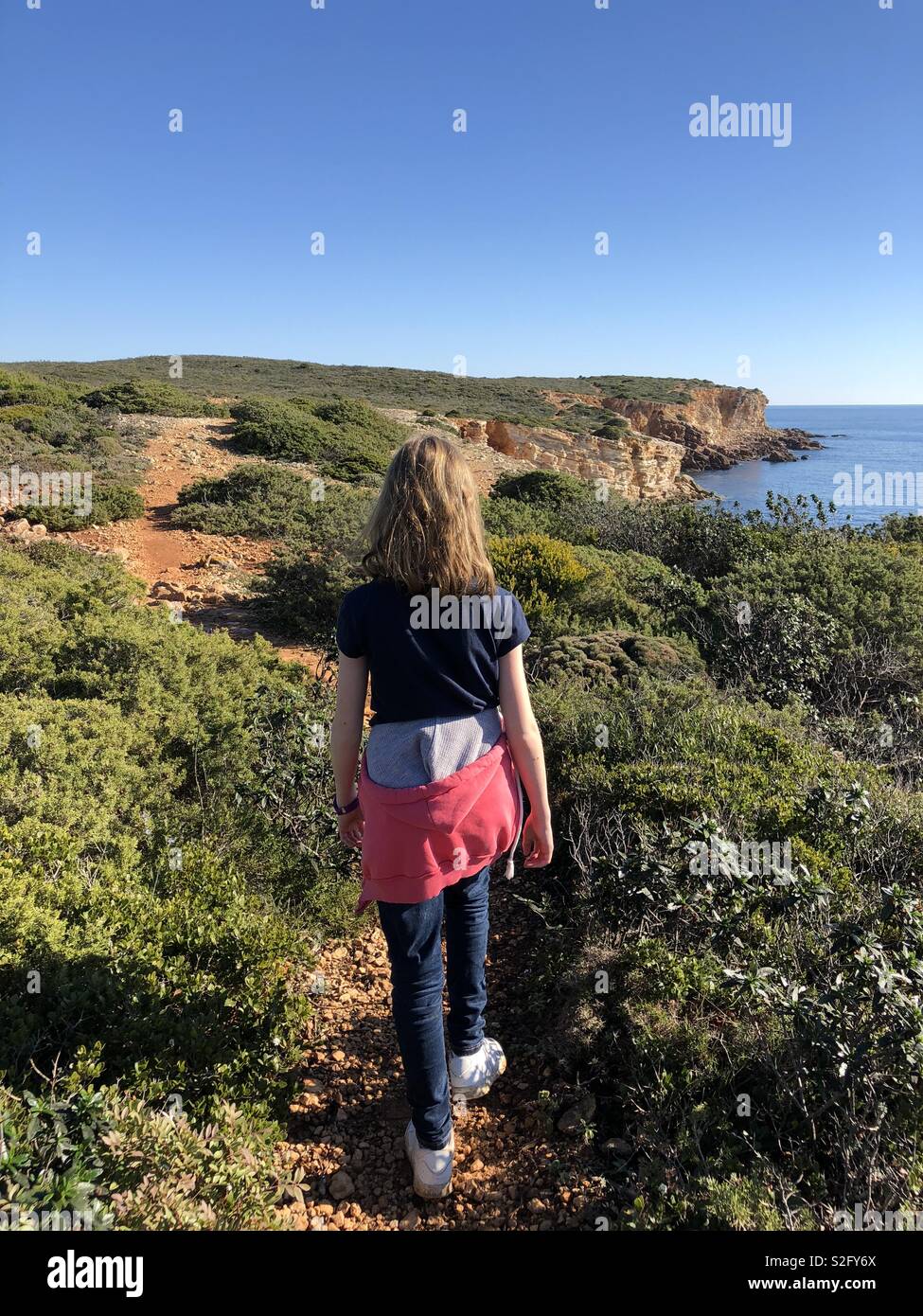 Girl walking along coastal footpath Rota Vincentina in Portugal - Smartphone Captured Stock Image