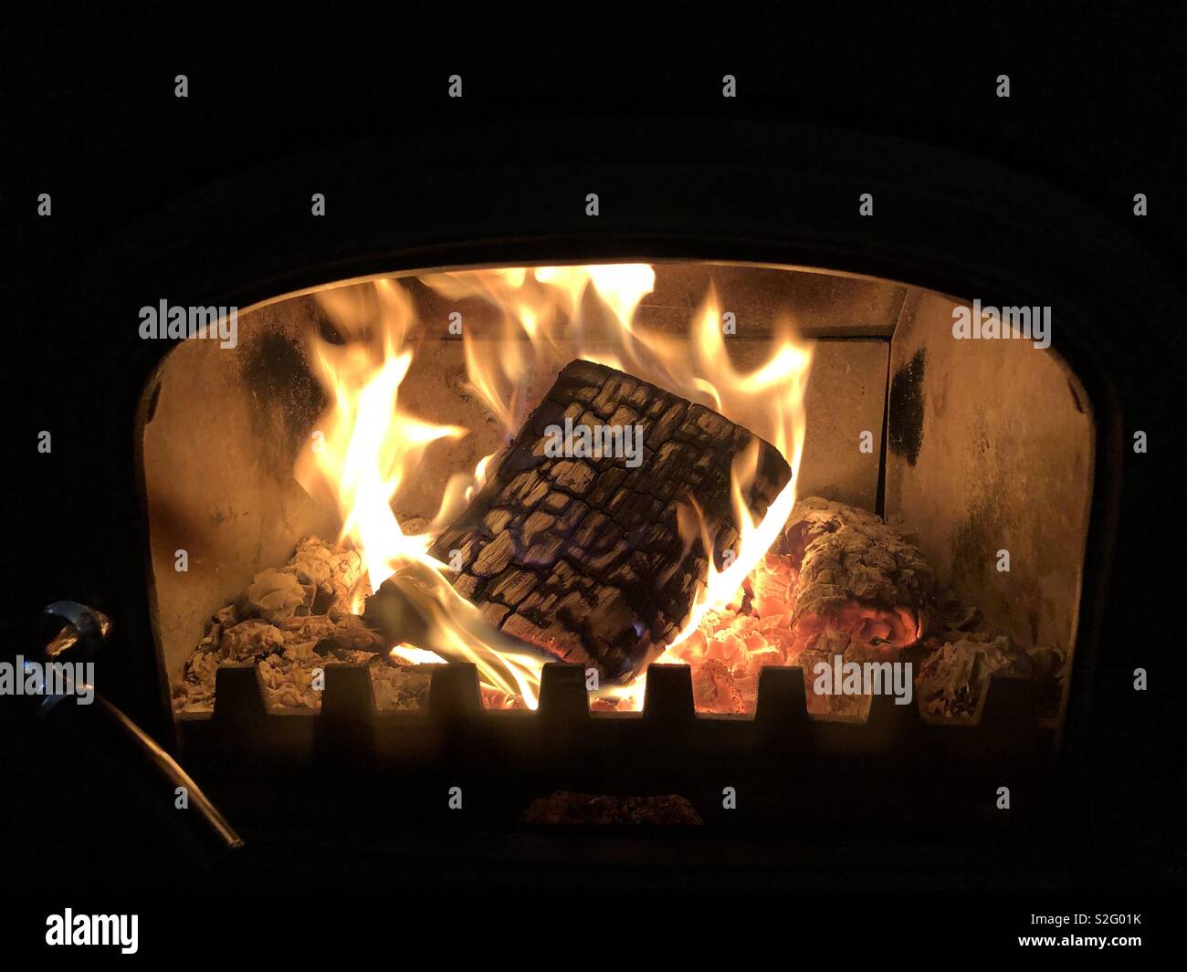 Log burning in a stove Stock Photo - Alamy