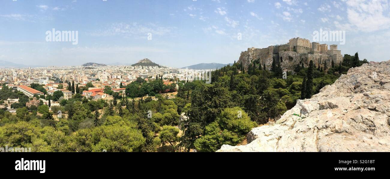The Acropolis, Mt. Lycabettus, and urban rooftops are shown in an elevated, panoramic view of Athens, Greece. Stock Photo