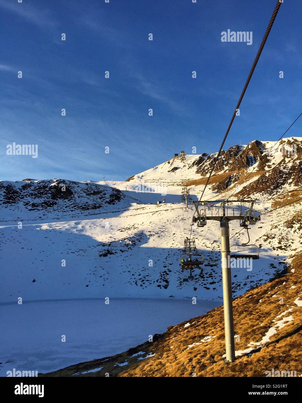Morning Sun on a chairlift in a French ski station. Stock Photo