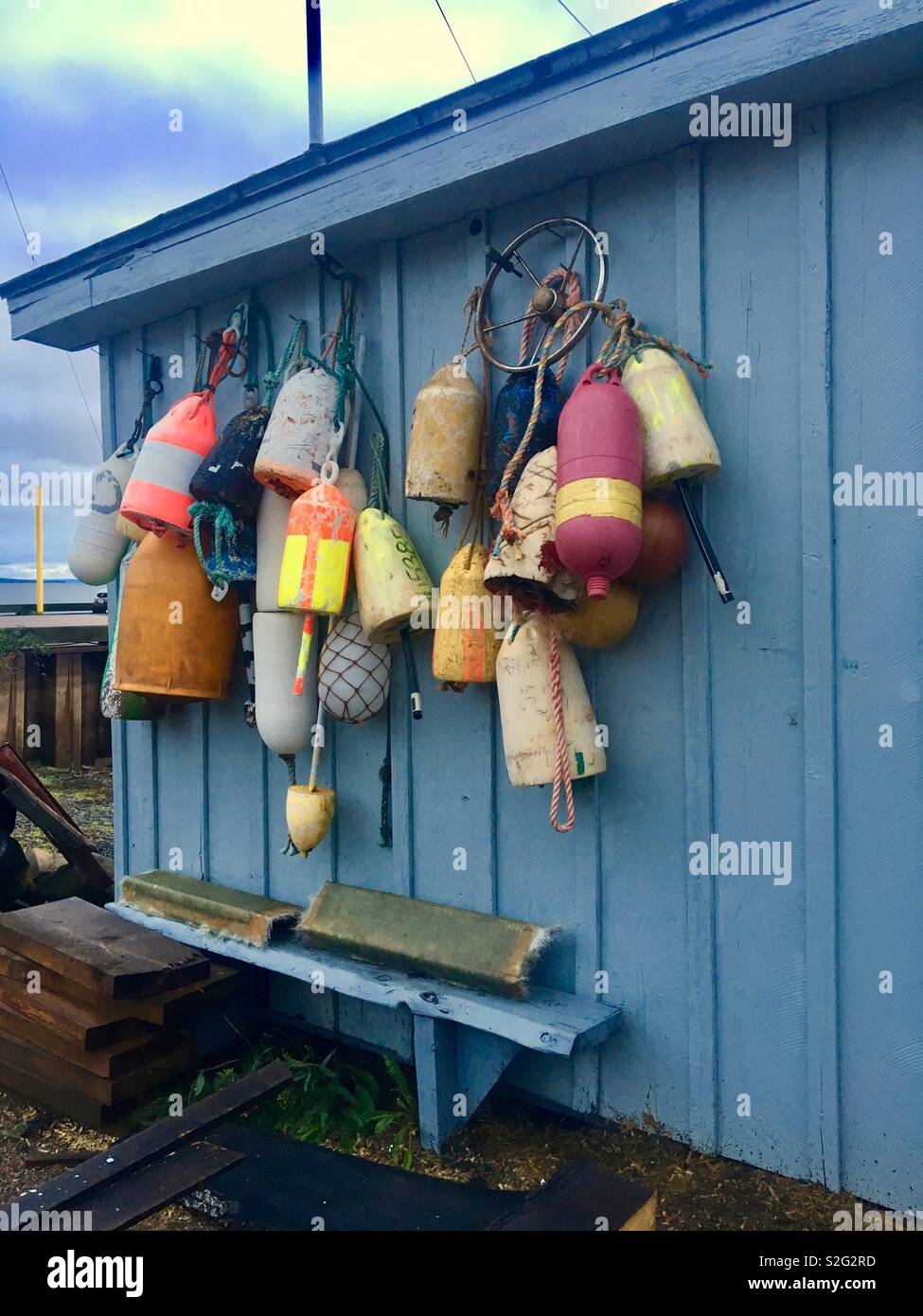 Fishing shed with old buoys hung up Stock Photo