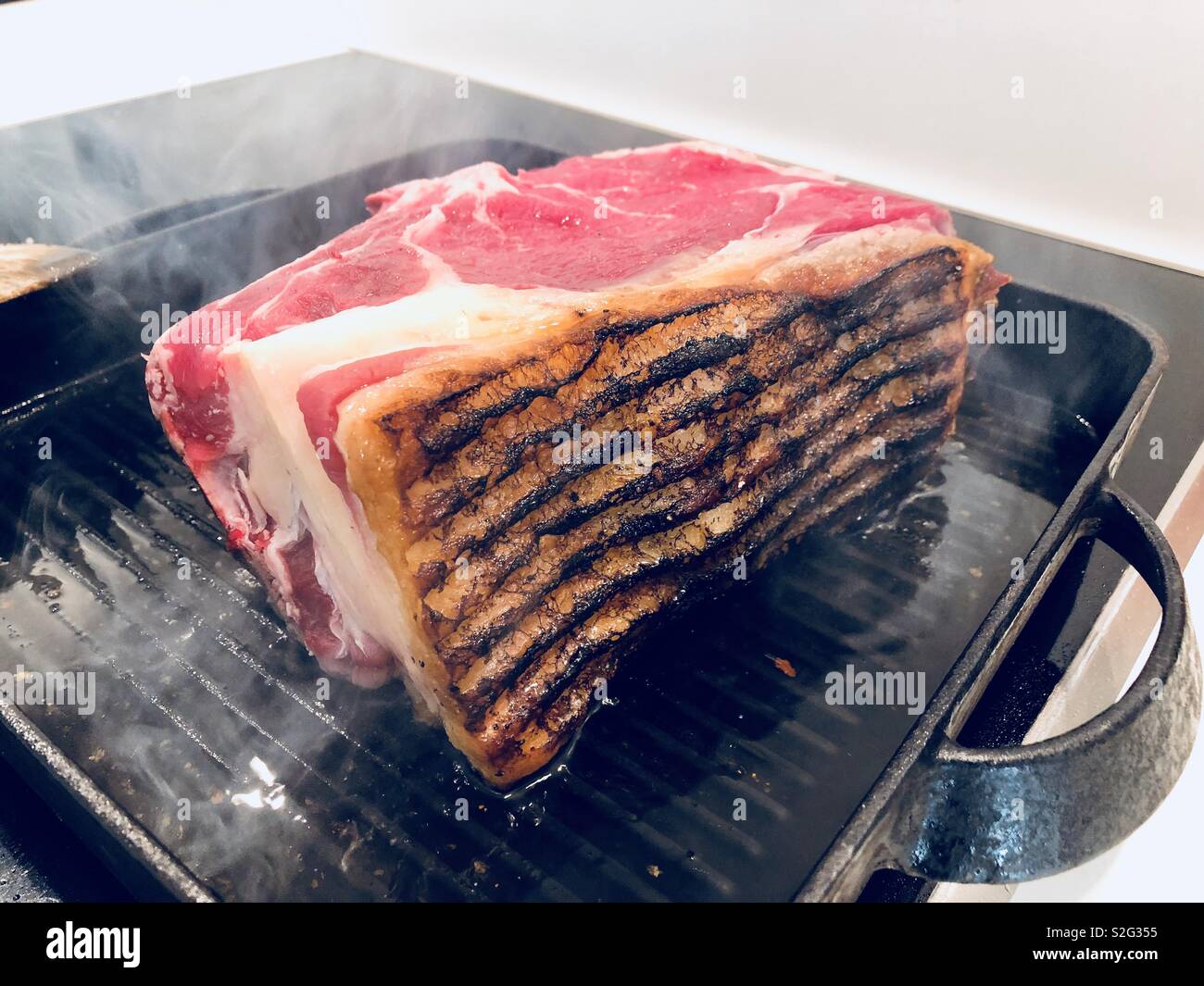 Searing a joint of roast beef Stock Photo