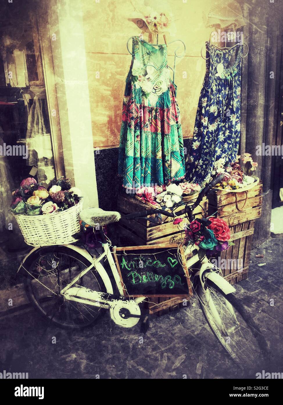 Bicycle and dresses on display outside shop. Madrid, Spain - Smartphone Captured Stock Image