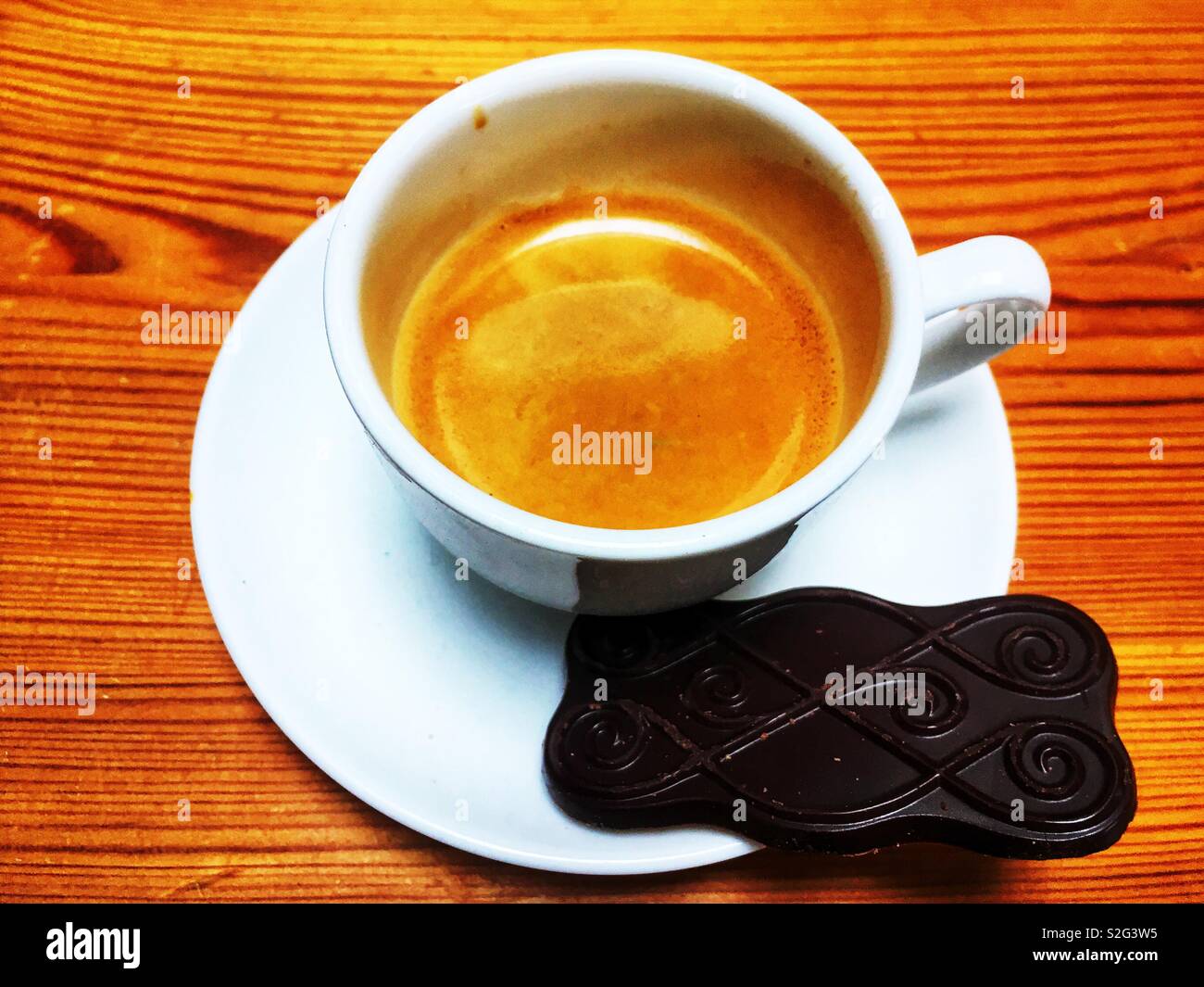 Espresso coffee with M&S Belgian dark chocolate set on a crisp biscuit - Smartphone Captured Stock Image