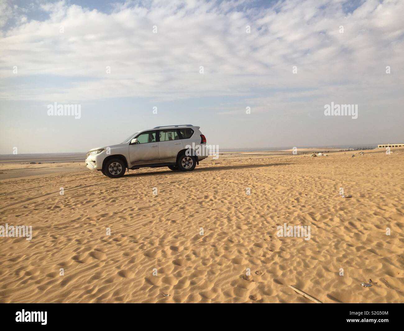 Land cruiser Prado at the top of a dune Stock Photo