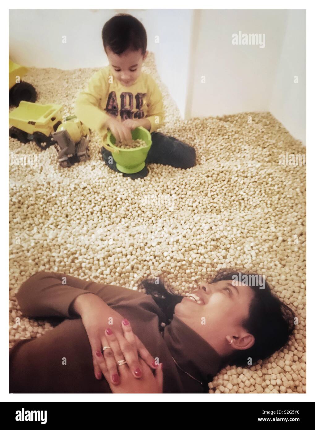 Kids construction site room where 3 years old Indonesian boy and his mom playing. - Smartphone Captured Stock Image