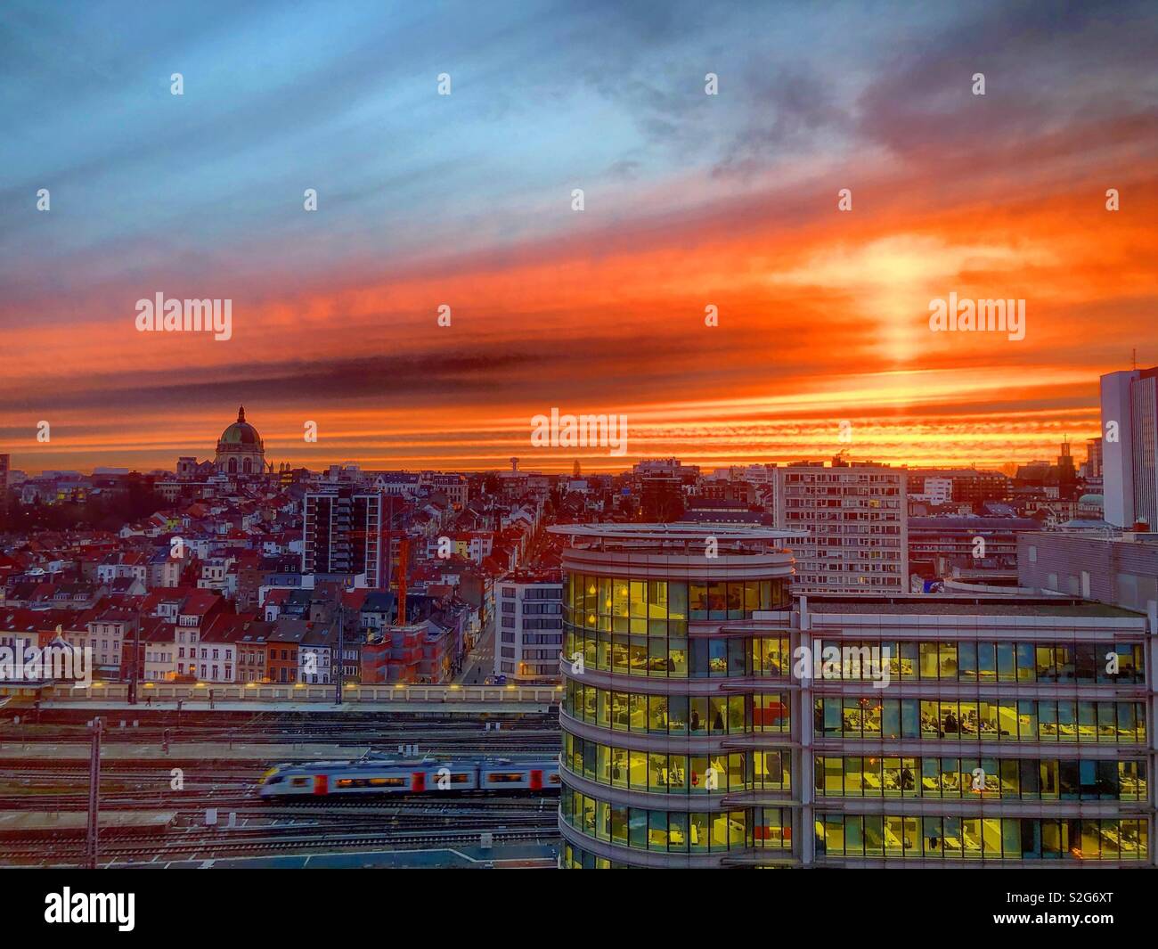 Dramatic and colorful fiery red sunrise over the city of brussels - Smartphone Captured Stock Image