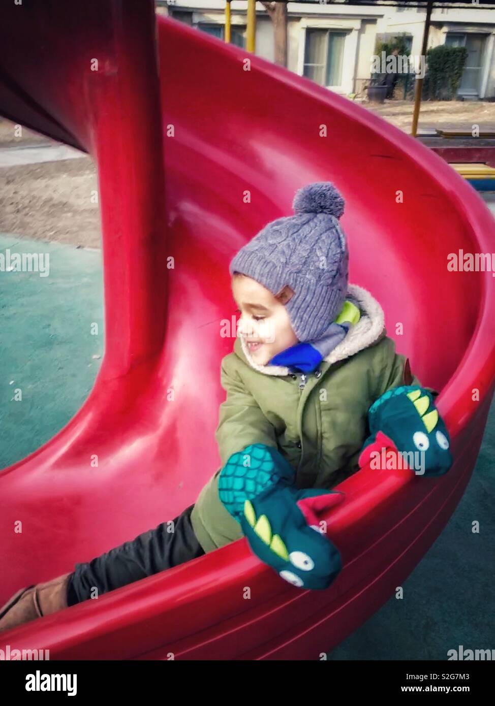 A boy on a slide in winter - Smartphone Captured Stock Image