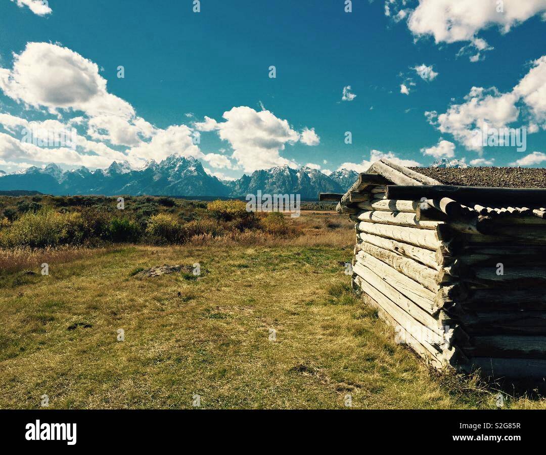 Abandoned Cunningham cabin looking out over the grand Teton mountains in Wyoming Stock Photo