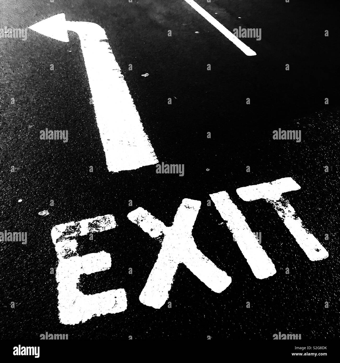 Exit left road markings. Glasgow, Scotland, United Kingdom. - Smartphone Captured Stock Image