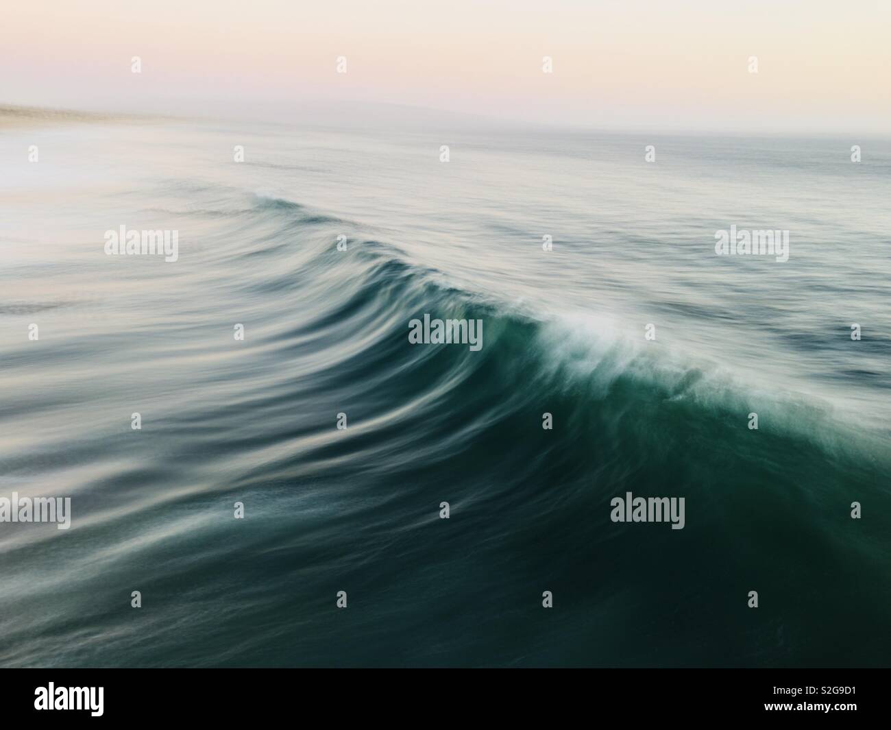 A speed blur of a wave breaking. Manhattan Beach, California USA. - Smartphone Captured Stock Image