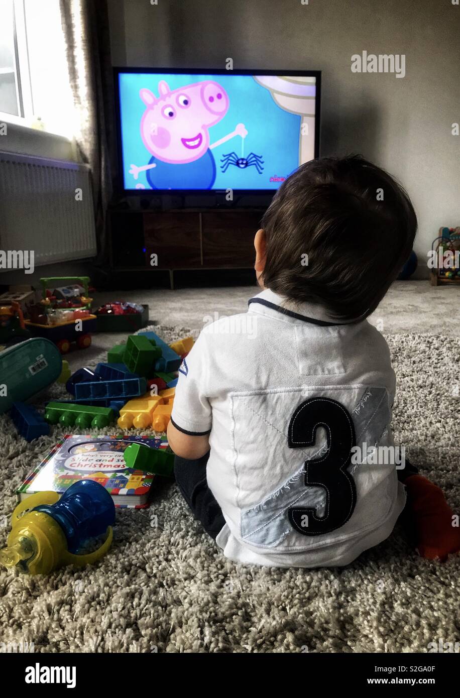 Toddler watching TV Stock Photo Alamy