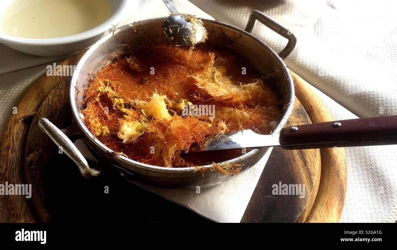 A pan of Kanafeh -A traditional Arab dessert served in a sweet shop in the old city of Acre in Israel. - Smartphone Captured Stock Image