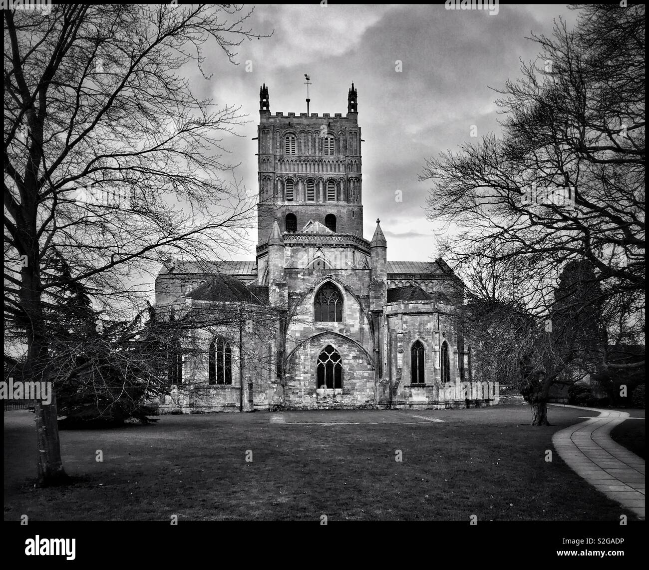 A moody & atmospheric monochrome image of Tewkesbury Abbey. This fantastic English Parish Church has a famous Romanesque Crossing Tower and hosts the annual Musica Deo Sacra. Photo © COLIN HOSKINS. - Smartphone Captured Stock Image